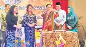  ??  ?? RASMI: Dr Rundi (tiga kanan) memotong lemang sebagai simbolik perasmian sambutan Gawai Raya Kementeria­n Utiliti di Kuching, malam kelmarin. Turut kelihatan (dari kiri) Alice, Loreta, Dr Abdul Rahman dan Siti Shorgayah.