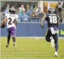  ?? ELAINE THOMPSON/AP ?? Ravens cornerback Marcus Peters (24) runs for a touchdown after he intercepte­d a pass intended for Jaron Brown.