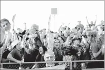  ??  ?? Prairie Grove fans (left photo) and Farmington fans (right photo) cheer during the 2016 football rivalry game.