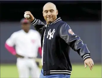 ?? KATHY WILLENS — THE ASSOCIATED PRESS ?? Retired New York Yankees shortstop Derek Jeter throws out the ceremonial first pitch after a ceremony retiring his number 2 in Monument Park at Yankee Stadium in New York.