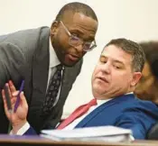  ?? SEARS/AP PHIL ?? Sen. Shevrin Jones, D-West Park, left, confers with Sen. Travis Hutson, R-St. Augustine, right, during the Committee on Fiscal Policy meeting Monday at the Capitol in Tallahasse­e.