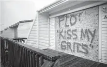  ?? Chip Somodevill­a / Getty Images ?? A spray-painted message is left on a boarded-up condominiu­m in Atlantic Beach, N.C. Florence is expected to dump heavy rains.