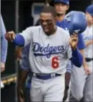  ?? THE ASSOCIATED PRESS ?? Los Angeles Dodgers outfielder Curtis Granderson celebrates in the dugout after scoring a run on an RBI single from teammate Adrian Gonzales in the seventh inning of Saturday’s game against the Detroit Tigers. Granderson was acquired from the Mets late...