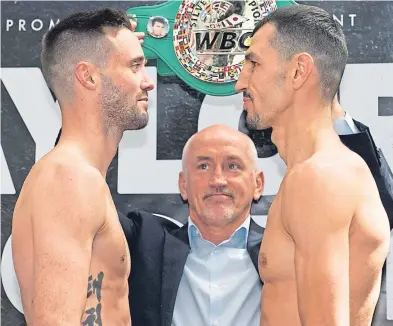  ?? SNS. ?? Josh Taylor, left, with Viktor Postol at the weigh-in and watched by promoter Barry McGuigan.