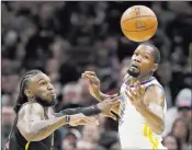  ?? Tony Dejak ?? The Associated Press Warriors forward Kevin Durant, right, and Cavaliers forward Jae Crowder track the ball in Golden State’s 118-108 victory Monday at Quicken Loans Arena.