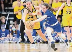  ?? Keith Gillett/Getty Images ?? Creighton’s Lauren Jensen, right, took advantage of new transfer rules to bite her old Iowa team with a game-winning shot last year.