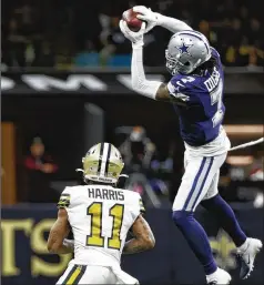  ?? DERICK HINGLE/AP ?? Cowboys cornerback Trevon Diggs intercepts a fourth-quarter pass intended for Saints wide receiver Deonte Harris during Thursday night’s 27-17 Dallas win. It was Diggs’ Nfl-leading ninth intercepti­on.