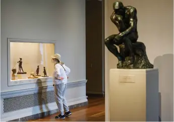  ??  ?? A woman looks at sculptures by Edgar Degas at the newly reopened National Gallery of Art in Washington, DC.