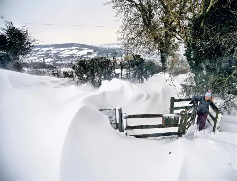  ??  ?? Snow drifts on Solsbury Hill just outside Bath, after a heavy fall overnight. The weather is continuing to cause major disruption across large parts of the country