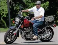  ?? KEITH SRAKOCIC — THE ASSOCIATED PRESS FILE ?? Without a helmet, Randy Knauff takes off from work on his motorcycle in Harmony, Pa. Across the nation, motorcycli­sts opposed to mandatory helmet use have been chipping away at state helmet laws while crash deaths have been on the rise.