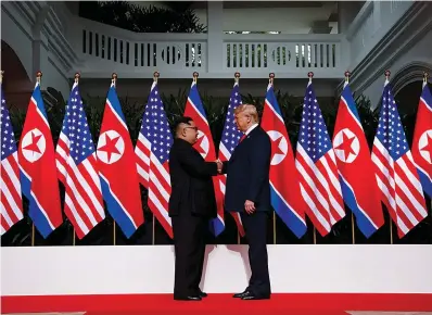  ?? AP Photo/Evan Vucci, File ?? ■ In this Tuesday file photo, U.S. President Donald Trump shakes hands as he meets with North Korean leader Kim Jong Un on Sentosa Island in Singapore.