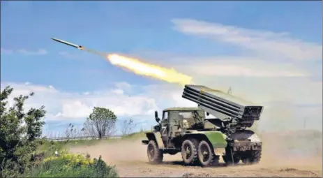 ?? AP ?? A Donetsk People’s Republic militia’s multiple rocket launcher fires from its position not far from Panteleimo­nivka, in territory under the government of the Donetsk People’s Republic, eastern Ukraine, on Saturday.