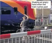  ??  ?? Shaking an angry hand when the train rushes past