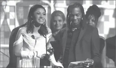  ?? Matt Sayles/AP ?? Grammy: Cardi B, left, accepts the award for best rap album for "Invasion of Privacy" as Offset looks on at the 61st annual Grammy Awards on Sunday in Los Angeles.