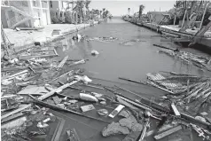  ??  ?? Second row, right Debris is visible in a canal on Big Pine Key in the Florida Keys. Debris has littered the canals since Hurricane Irma ravaged the middle Keys in September.