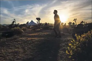  ?? Photograph­s by Gina Ferazzi Los Angeles Times ?? JOSE SANCHEZ-CASTRO of Pasadena ferries his luggage to Lazy Sky Retreat in Joshua Tree last month.