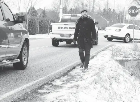  ?? NICK BRANCACCIO ?? Ward 9 Coun. Kieran McKenzie walks along part of the Sixth Concession near Holburn Street on Wednesday. To improve safety, McKenzie is calling for $7.5 million in improvemen­ts to the former country road that services subdivisio­ns and many newer homes in the area.