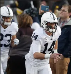  ?? MATTHEW PUTNEY — THE ASSOCIATED PRESS ?? Penn State quarterbac­k leads Penn State onto the field against Iowa Saturday night. Clifford overcame a slow start to keep the Nittany Lions undefeated with a 17-12victory over the Hawkeyes.