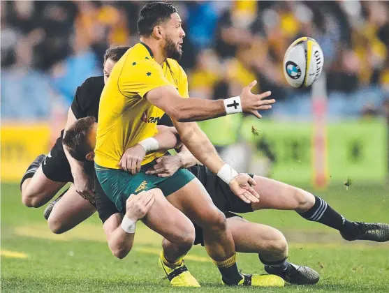  ?? BLACKOUT: Wallaby Curtis Rona is tackled during Saturday night’s Bledisloe Cup match against the All Blacks at ANZ Stadium. ??