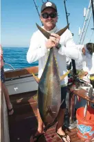  ??  ?? Capt. Ben Brownlee hoists a yellowfin. He’s also handy with a water balloon.