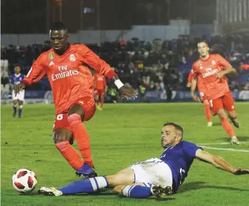  ?? AP ?? Real Madrid’s Vinicius Junior (left) duels for the ball during the Copa del Rey match against Melilla at the Municipal Alvarez Claro Stadium on Wednesday.