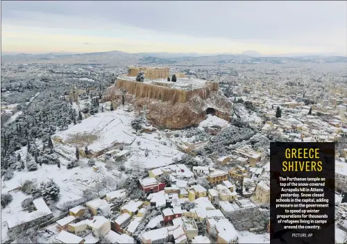  ??  ?? The Parthenon temple on top of the snow-covered Acropolis hill in Athens yesterday. Snow closed schools in the capital, adding pressure on the government to speed up winter preparatio­ns for thousands of refugees living in camps around the country.