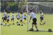  ?? ?? Soccer nets are wheeled onto the fields.