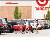  ??  ?? In this file photo, shoppers take purchases to their vehicle in the parking lot of a Target store in Marlboroug­h, Massachuse­tts. (AP)