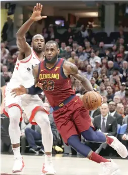  ?? | TONY DEJAK/ AP ?? The Cavaliers’ LeBron James ( 35 points, 17 assists) drives past the Raptors’ Serge Ibaka during the second half Wednesday in Cleveland.