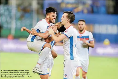  ?? PIC/PTI ?? FC Goa (white jersey) player Mandar Dessai celebratin­g with teammates after scoring a goal against Chennaiyin FC during the Indian Super League (ISL) match in Chennai