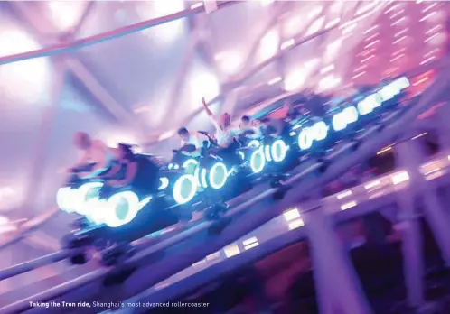  ??  ?? Taking the Tron ride, Shanghai's most advanced rollercoas­ter