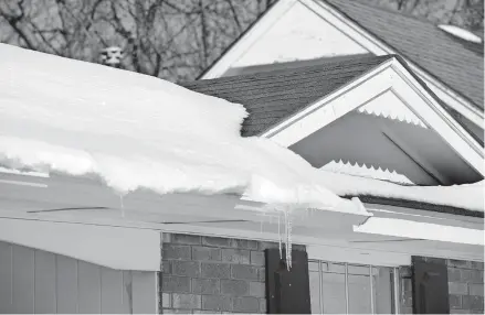  ??  ?? Snow on the roof of an Edmond home from an earlier snow storm. Ice damming can result from storms like the ones last week, causing damage to the roof and leaks inside the house. [THE OKLAHOMAN ARCHIVES]