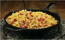  ?? Tribune News Service ?? ■ For maque choux, sauté chopped onion and bell peppers in fat, then stir in the corn, garlic and bacon. Finish the dish with seasonings and a little cream.