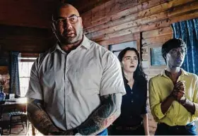  ?? Universal Pictures via Associated Press ?? From left, Dave Bautista, Abby Quinn and Nikki Amuka-Bird in a scene from “Knock at the Cabin.”
