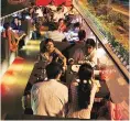  ?? REUTERS ?? People dine on a double-decker bus which has been converted to a mobile restaurant in Ahmedabad