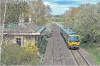  ?? JOHN STRETTON ?? In bright spring sunshine, ‘Networker’ No. 165126 speeds south past the erstwhile Aynho station building on April 8 with 2V39, the 12.35 Banbury to Didcot Parkway local.