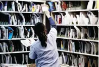  ??  ?? A letter carrier prepares mail for delivery at the United States Postal Service (USPS) Joseph Curseen Jr. and Thomas Morris Jr. processing and distributi­on center in Washington, D.C., US. (Bloomberg file photo)