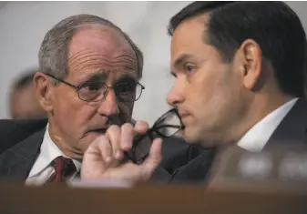  ?? J. Scott Applewhite / Associated Press ?? Sen. James Risch (left), R-Idaho, and Sen. Marco Rubio, R-Fla., confer at a Senate committee hearing as former FBI Director James Comey testifies about what President Trump said to him.