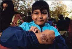  ?? ?? Avish Punia, 8, shows off his henna tattoo at the Diwali celebratio­n in Westport.