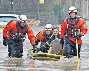  ??  ?? Saved: emergency services rescue residents by boat from flooded homes in Whalley, Lancs yesterday – the village sits alongside the swollen River Calder