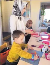  ?? COURTESY OF KATHY CHILTON ?? ABOVE: Rabia Orhan and her son, Alp, are among about two dozen people who met Feb. 1 at a North Valley home to create Valentine’s Day cards for clients of Meals on Wheels. At the far end of the table is Catie Glover.