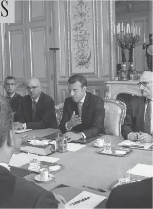  ?? THIBAULT CAMUS / AFP / GETTY IMAGES ?? French President Emmanuel Macron, centre, meets with the president of the Venezuelan parliament, Julio Borges, left, in Paris on Monday.