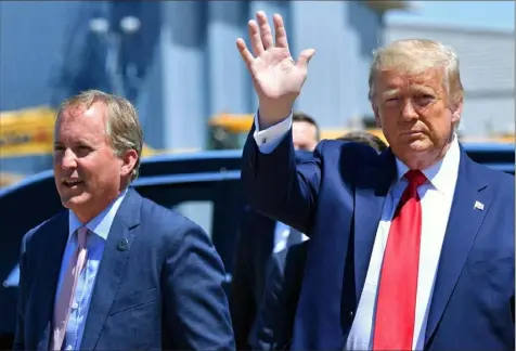  ?? Nicholas Kamm/AFP via Getty Images ?? President Donald Trump waves alongside Texas Attorney General Ken Paxton in Dallas, Texas, in July.