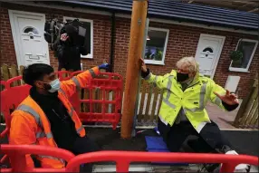  ?? (AP/Peter Byrne) ?? British Prime Minister Boris Johnson meets apprentice Zuber Shaikh (left) who was demonstrat­ing groundwork laying during Johnson’s visit Friday to a training center in Bolton.