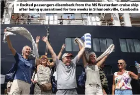  ??  ?? > Excited passengers disembark from the MS Westerdam cruise ship after being quarantine­d for two weeks in Sihanoukvi­lle, Cambodia