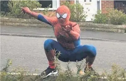  ?? Paul Husband ?? ●●Using their hour of exercise a day, pals Andrew Baldock and Jason Baird have been using their time to visit streets in Stockport dressed as Spider-Man