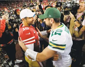  ?? Carlos Avila Gonzalez / San Franciso Chronicle ?? Quarterbac­ks Jimmy Garoppolo (10) and Aaron Rogers (12) meet at midfield after the San Francisco 49ers defeated the Green Bay Packers 37-8 at Levi’s Stadium in Santa Clara, Calif., in November. The teams meet again in Sunday’s NFC Championsh­ip.