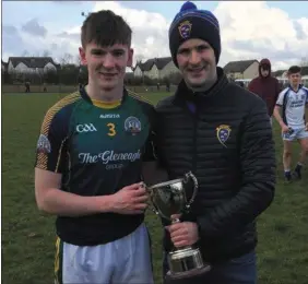  ??  ?? St Brendan’s College team captain Kieran O’Donoghue receiving the Frewen Cup from Munster Post-Primary Servicing Officer John Brennan