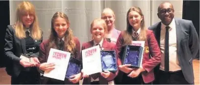  ??  ?? Team members (left to right) Esther Bird, Anna Wilkie and Amelie Mayou with (left to right adults) teacher Caroline Burke, Rotarian Mary Grant and headteache­r Emmanuel Botwe