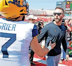  ?? [AP PHOTO] ?? Texas Tech coach Kliff Kingsbury congratula­tes West Virginia quarterbac­k Will Grier after the Mountainee­rs’ victory Saturday.